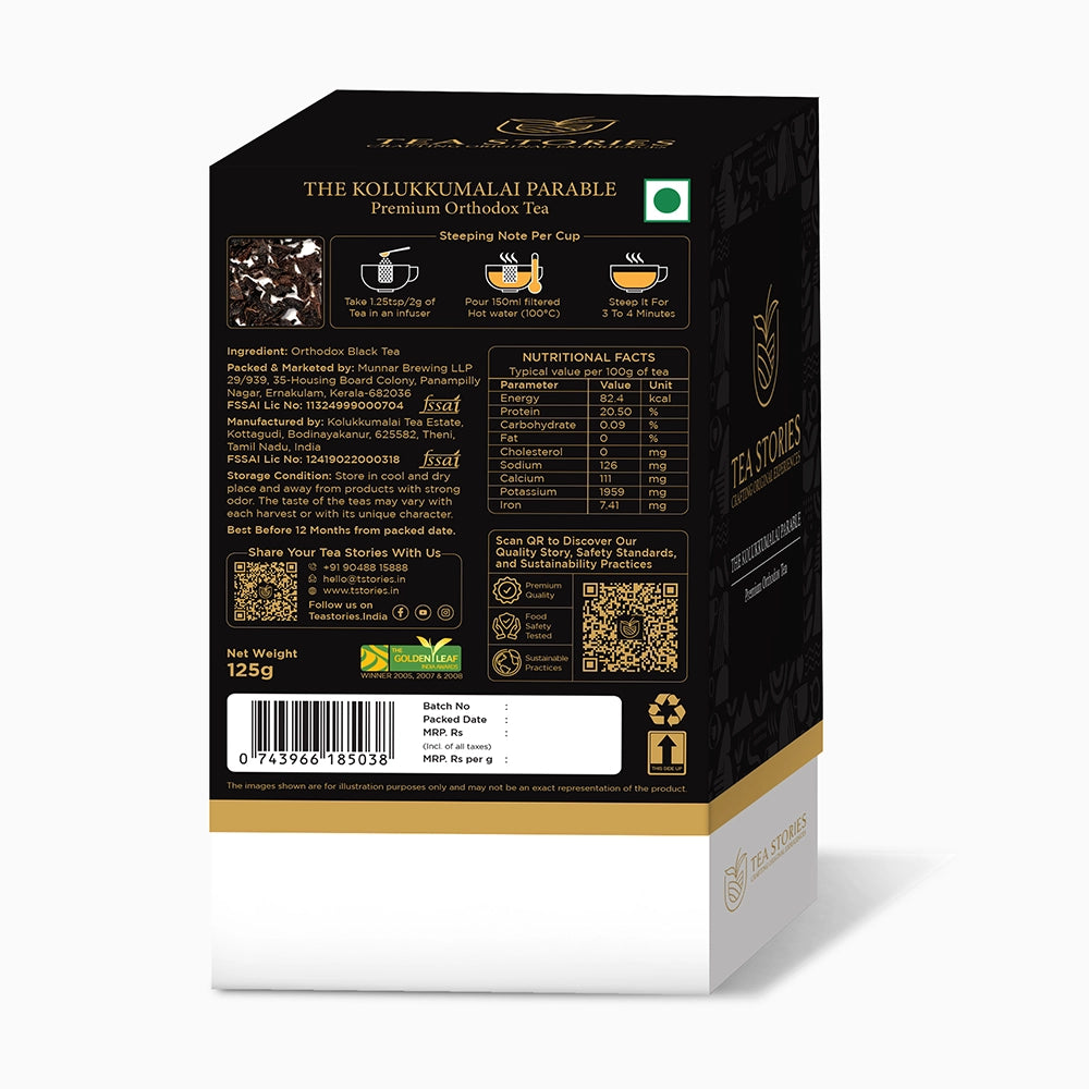 Golden tea cup with boxed Kulukkumalai tea — branding and presentation harmony.